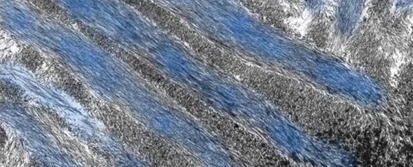 Close-up of a textured abstract surface with sweeping gray, white, and blue streaks resembling layered rock, ice, or brushstrokes.